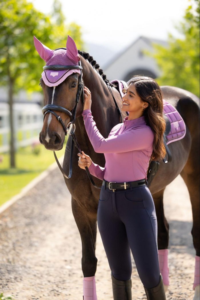 Rider and horse fully coordinated in the LeMieux SS26 Mallow soft purple collection, featuring a matching base layer, saddle pad, and fly hood.