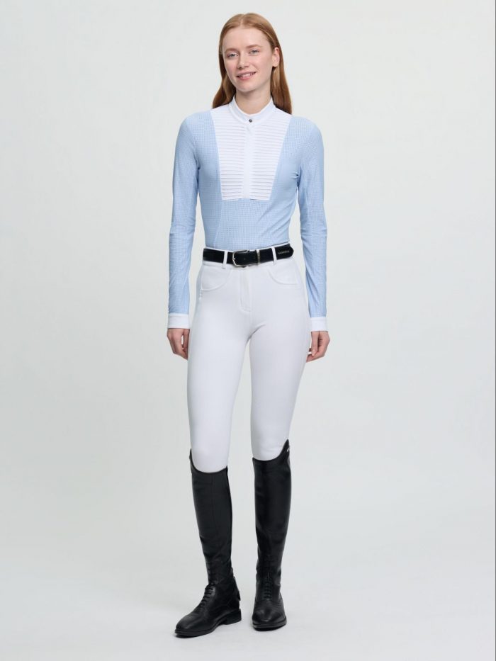 Equestrian wearing the LeMieux SS26 Mist ethereal grey textured long-sleeve show shirt paired with white competition breeches and riding boots.