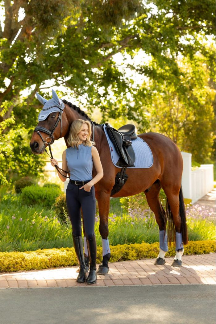 Equestrian and horse matching in the LeMieux SS26 Powder Blue summer collection, showing a sleeveless base layer, saddle pad, and fly hood.