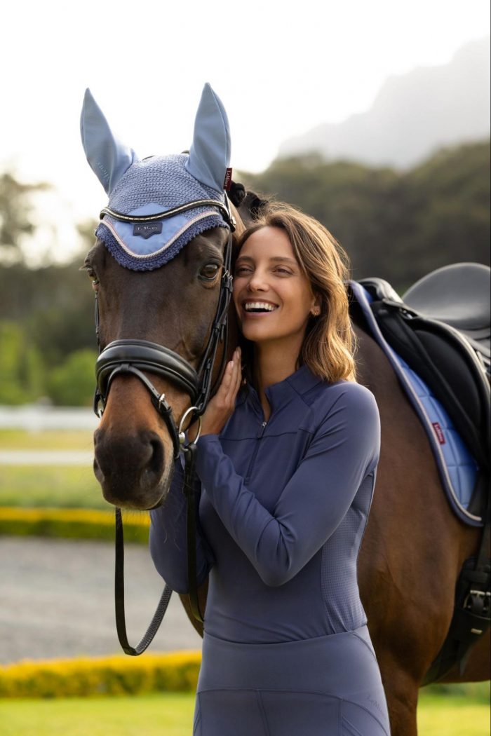 Equestrian and brown horse coordinating in the new LeMieux SS26 Shadow charcoal-grey base layer and matching fly hood.